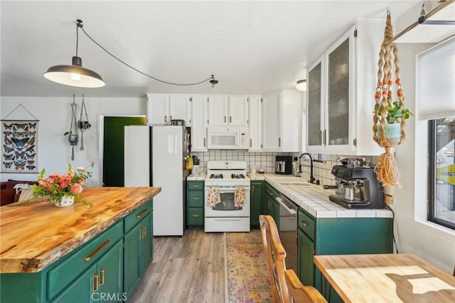 kitchen with white cabinets, green cabinets, white appliances, and sink