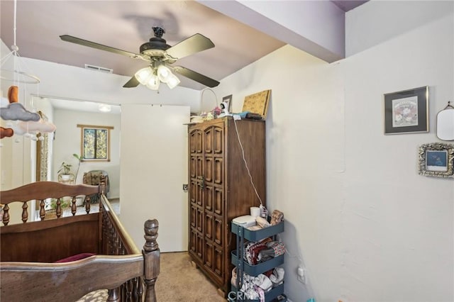 bedroom featuring light carpet and ceiling fan