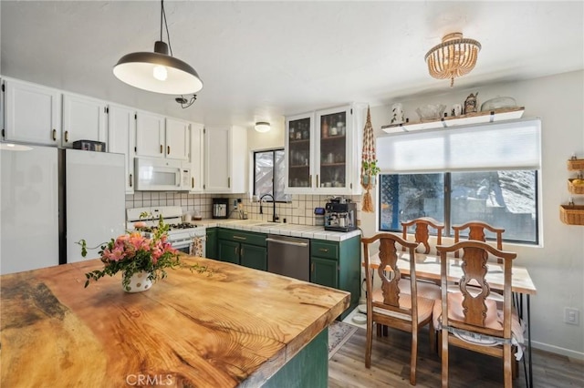 kitchen with white cabinetry, tasteful backsplash, green cabinets, decorative light fixtures, and white appliances