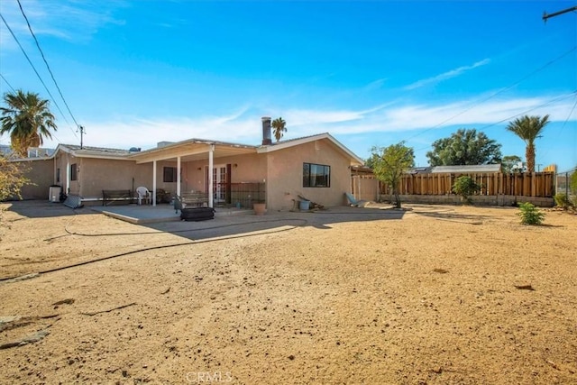 rear view of property featuring a patio area