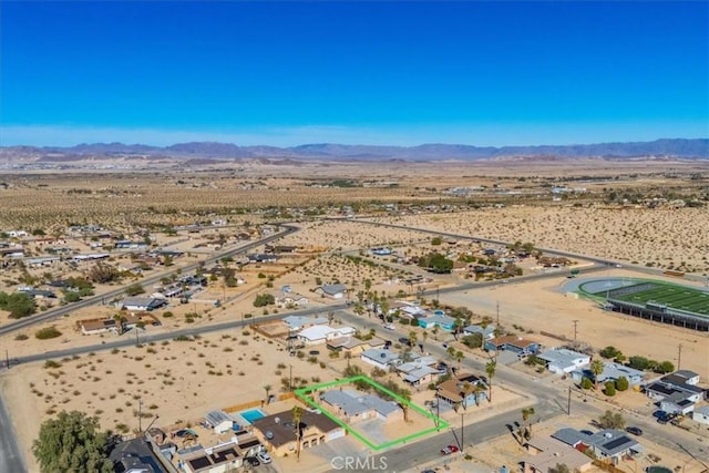 birds eye view of property with a mountain view