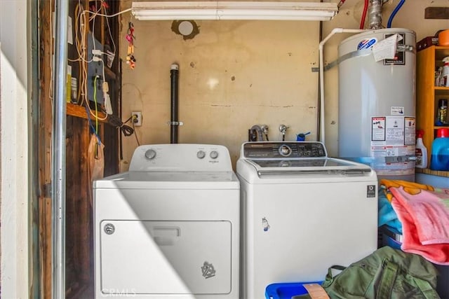 washroom with washer and dryer and strapped water heater