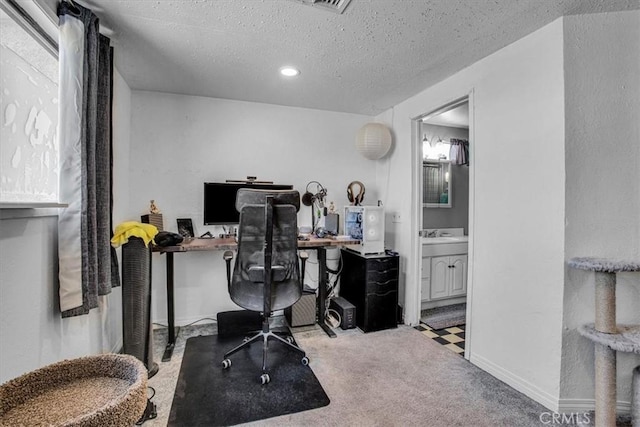 office space featuring light colored carpet and a textured ceiling