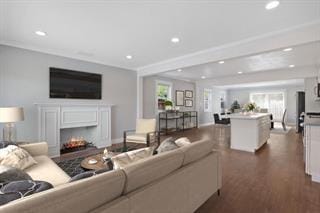 living room with plenty of natural light and dark wood-type flooring