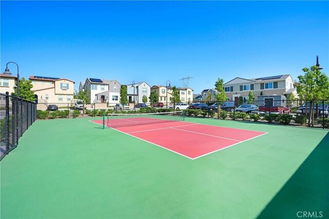 15974 Jamie Ln Unit 1, Fontana, CA 92336 - view of tennis court featuring fence and a residential view