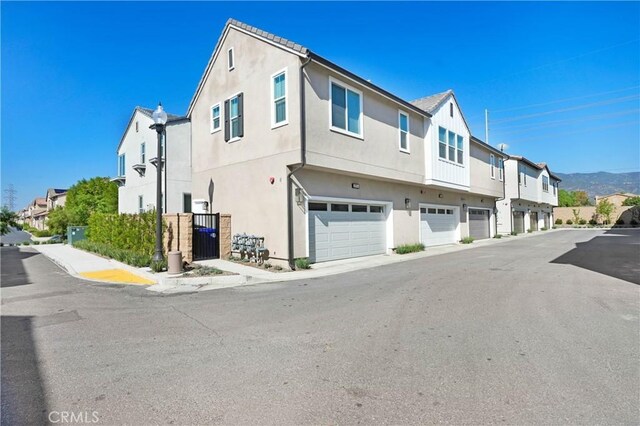 15974 Jamie Ln Unit 1, Fontana, CA 92336 - view of front of home featuring a garage, stucco siding, and a residential view