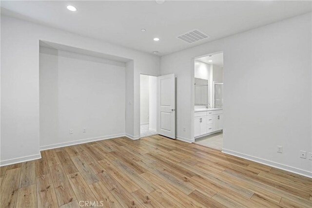 15974 Jamie Ln Unit 1, Fontana, CA 92336 - unfurnished bedroom featuring light wood finished floors, baseboards, recessed lighting, and connected bathroom
