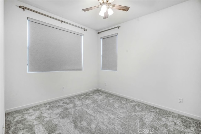 empty room with light colored carpet and ceiling fan