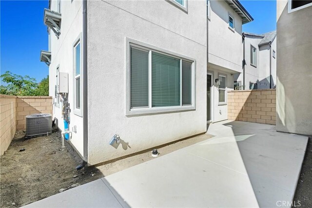 15974 Jamie Ln Unit 1, Fontana, CA 92336 - view of property exterior with central AC unit, fence, a patio, and stucco siding