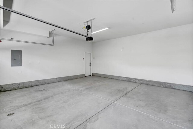 15974 Jamie Ln Unit 1, Fontana, CA 92336 - garage with electric panel, a garage door opener, and baseboards