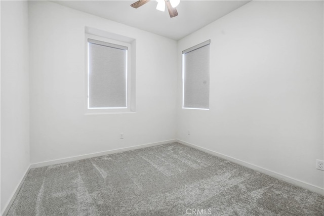 empty room with ceiling fan and carpet