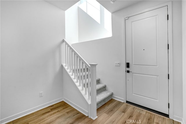 foyer entrance with light hardwood / wood-style floors