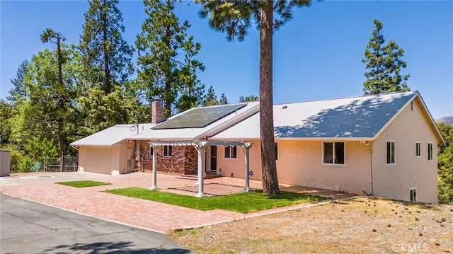 exterior space featuring solar panels and a patio