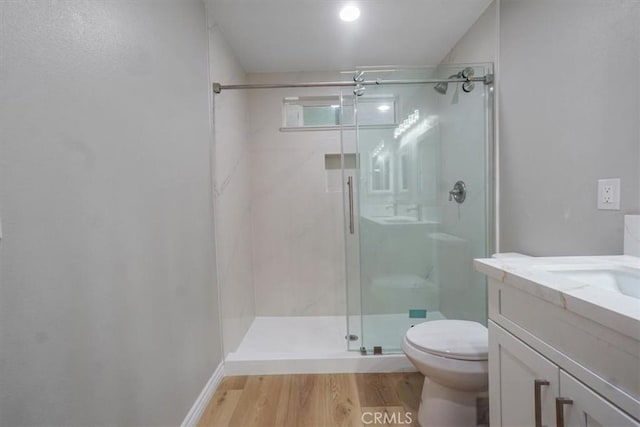 bathroom with vanity, hardwood / wood-style flooring, toilet, and an enclosed shower