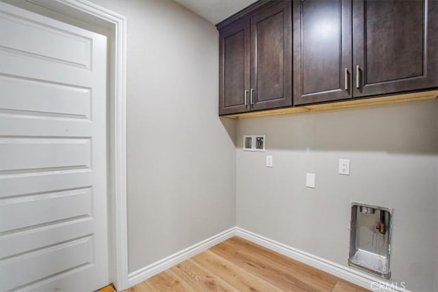 laundry room with cabinets, washer hookup, and light hardwood / wood-style floors