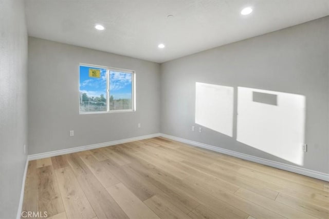 spare room with light wood-type flooring