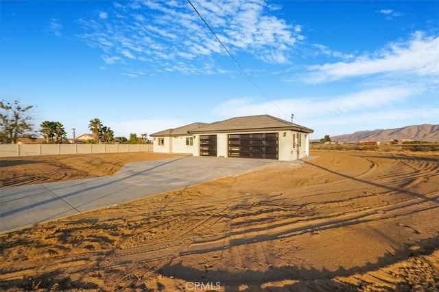 view of front of property with a mountain view and a garage