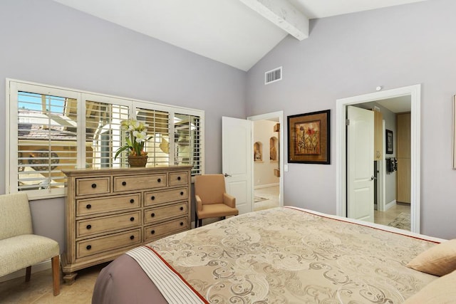 bedroom featuring beam ceiling, high vaulted ceiling, and ensuite bath