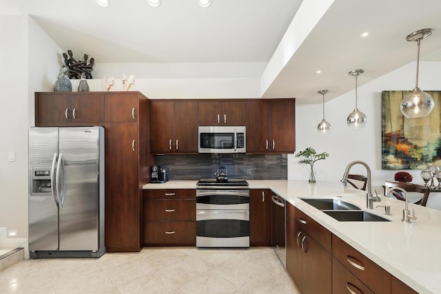 kitchen with sink, hanging light fixtures, stainless steel appliances, backsplash, and light tile patterned flooring