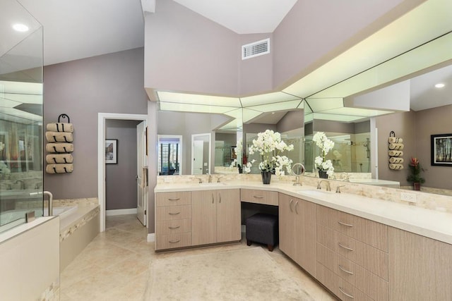 bathroom with tile patterned floors, vanity, and separate shower and tub