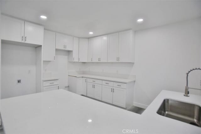 kitchen featuring sink and white cabinets