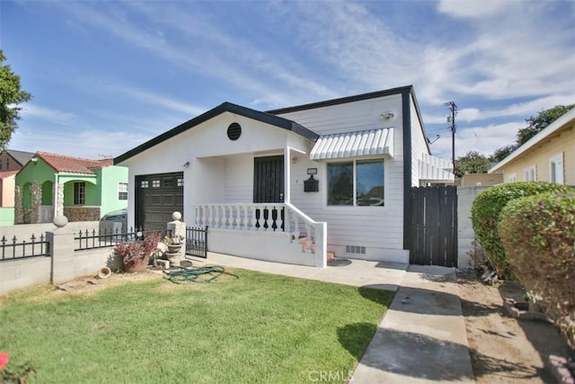 view of front of house with a garage and a front lawn