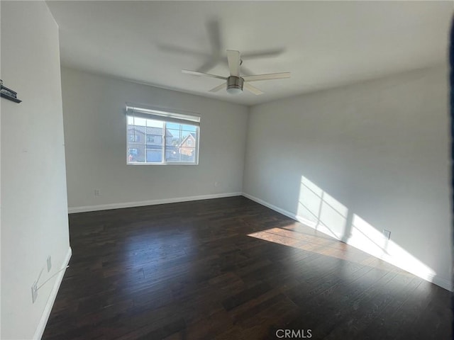 empty room featuring ceiling fan and dark hardwood / wood-style floors