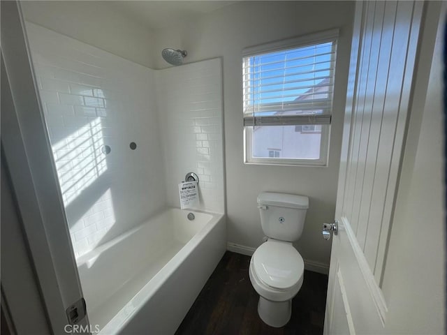 bathroom featuring hardwood / wood-style floors, toilet, shower / bathtub combination, and a healthy amount of sunlight