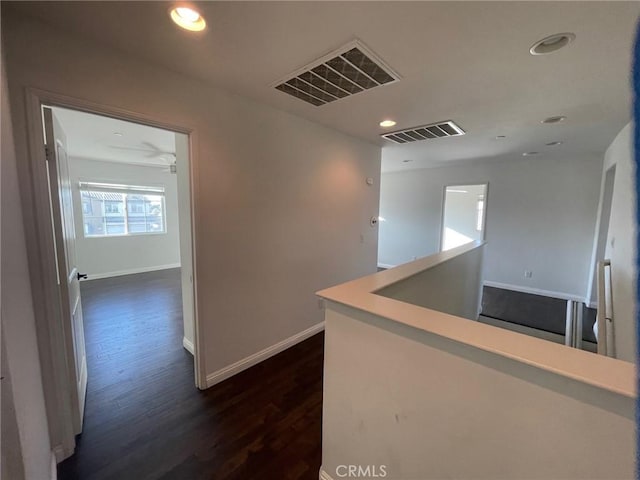 corridor with dark hardwood / wood-style floors