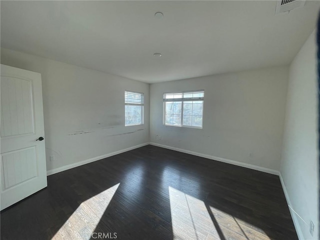 unfurnished room with dark wood-type flooring