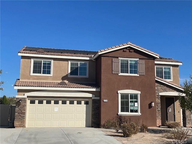 view of front of house with solar panels and a garage