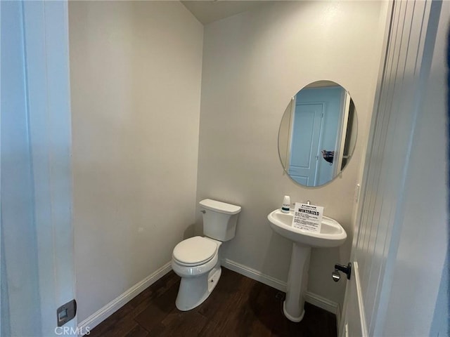 bathroom featuring hardwood / wood-style floors and toilet