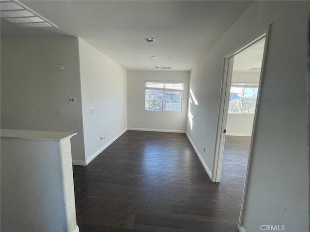 interior space with plenty of natural light and dark hardwood / wood-style floors