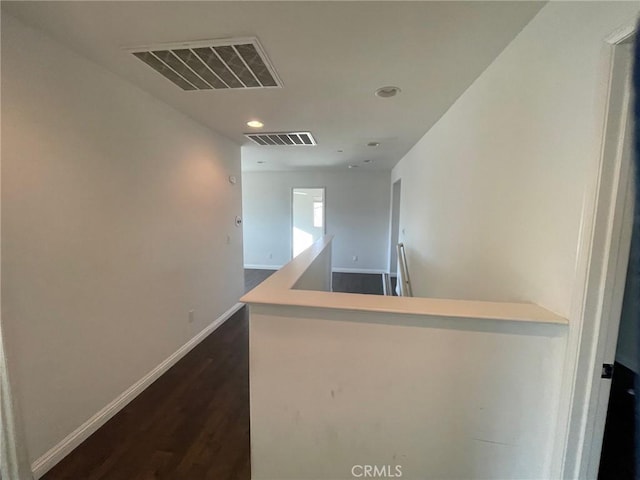 hallway with dark wood-type flooring