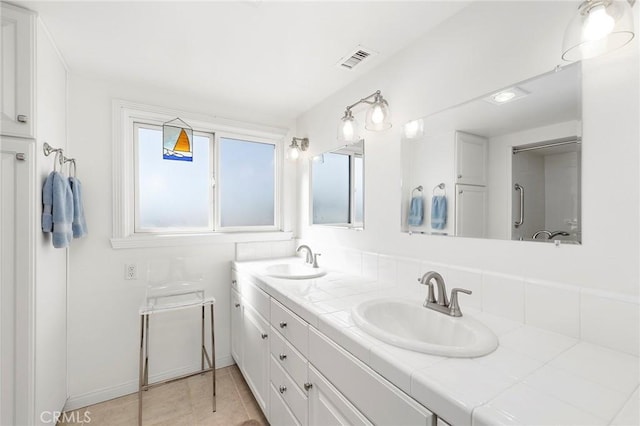 bathroom with vanity and tile patterned floors