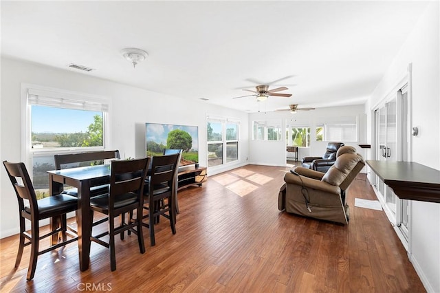 dining area featuring hardwood / wood-style flooring, ceiling fan, and a healthy amount of sunlight