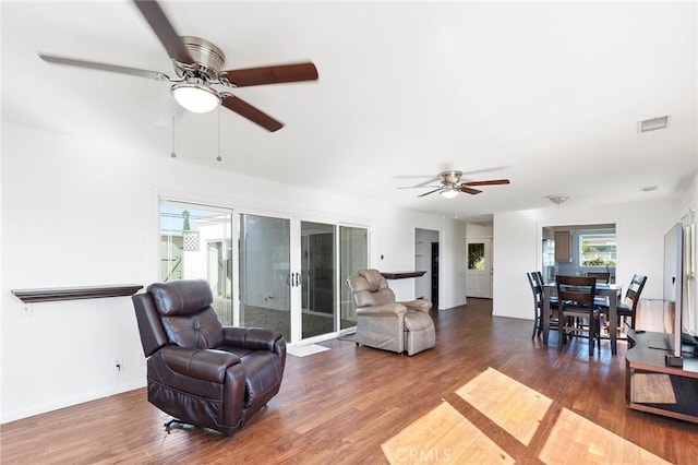 living room with hardwood / wood-style floors, french doors, and ceiling fan