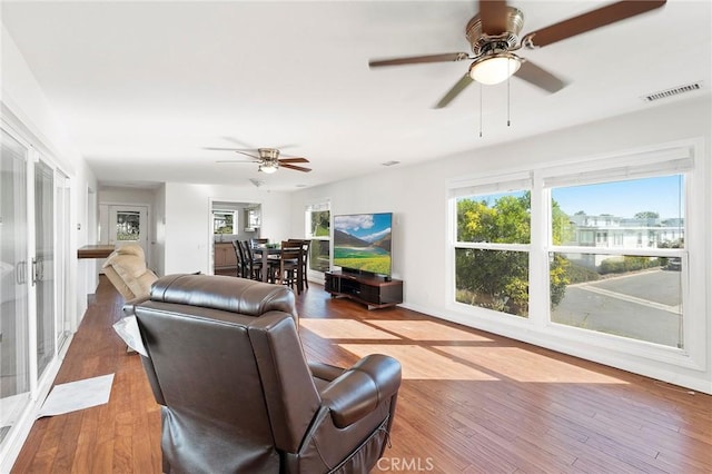 living room featuring hardwood / wood-style flooring and ceiling fan