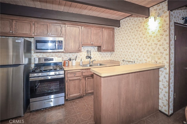 kitchen featuring wood ceiling, kitchen peninsula, beam ceiling, appliances with stainless steel finishes, and sink