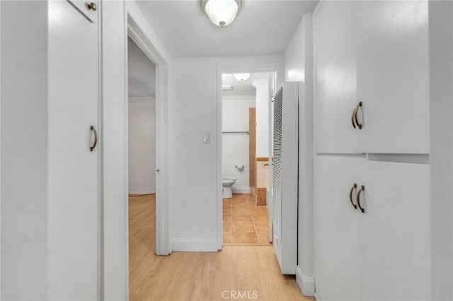 hall featuring light wood-type flooring and crown molding