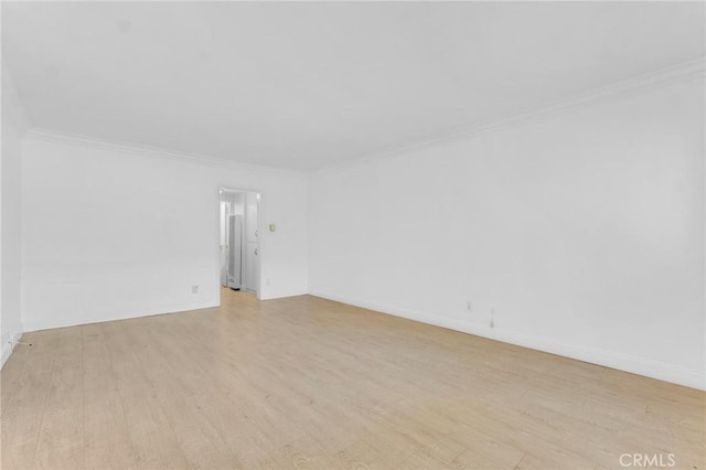 spare room with light hardwood / wood-style flooring and ornamental molding