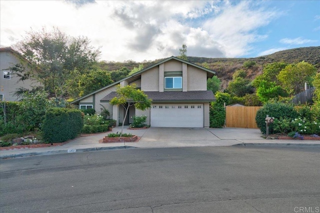 view of front of home with a mountain view and a garage