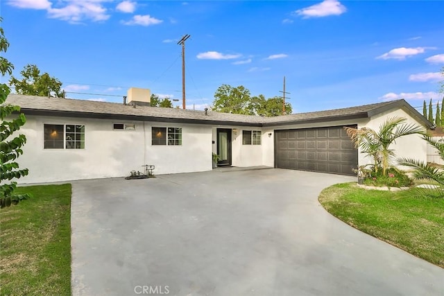 ranch-style home with a front yard and a garage