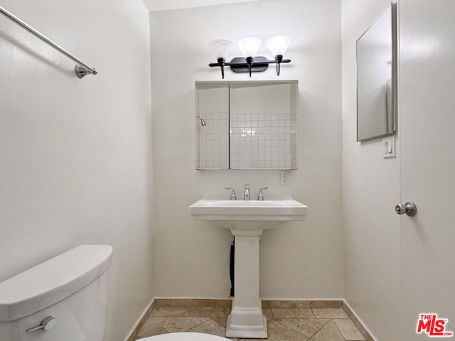 bathroom featuring tile patterned flooring and toilet