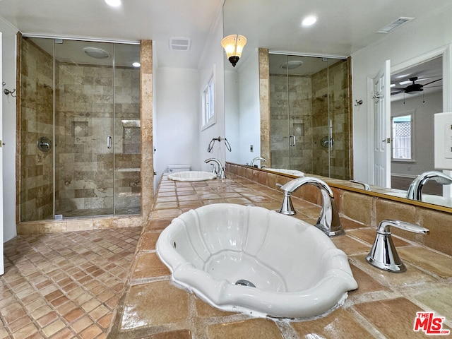 bathroom featuring ceiling fan, a healthy amount of sunlight, and an enclosed shower