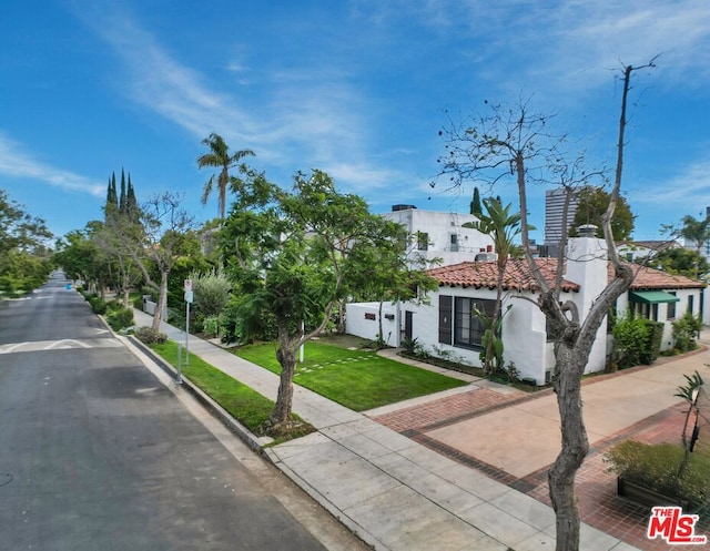 mediterranean / spanish-style house featuring a front lawn