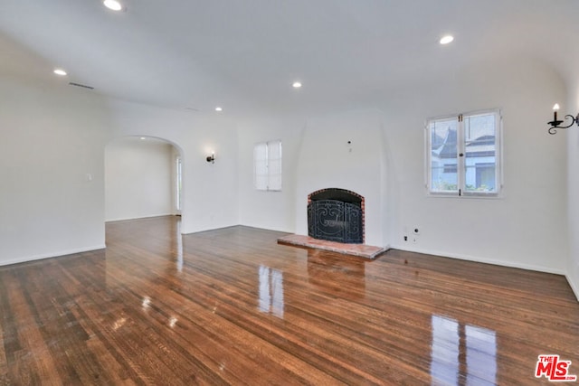 unfurnished living room featuring dark hardwood / wood-style flooring