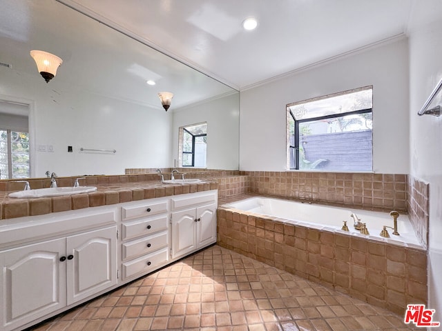 bathroom with tiled bath, crown molding, and vanity