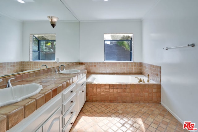 bathroom featuring decorative backsplash, vanity, tiled bath, and ornamental molding