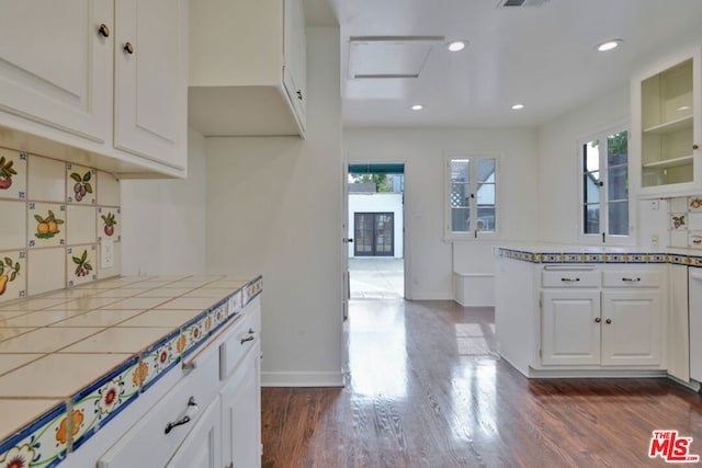 kitchen with tile countertops, dark hardwood / wood-style floors, and white cabinetry